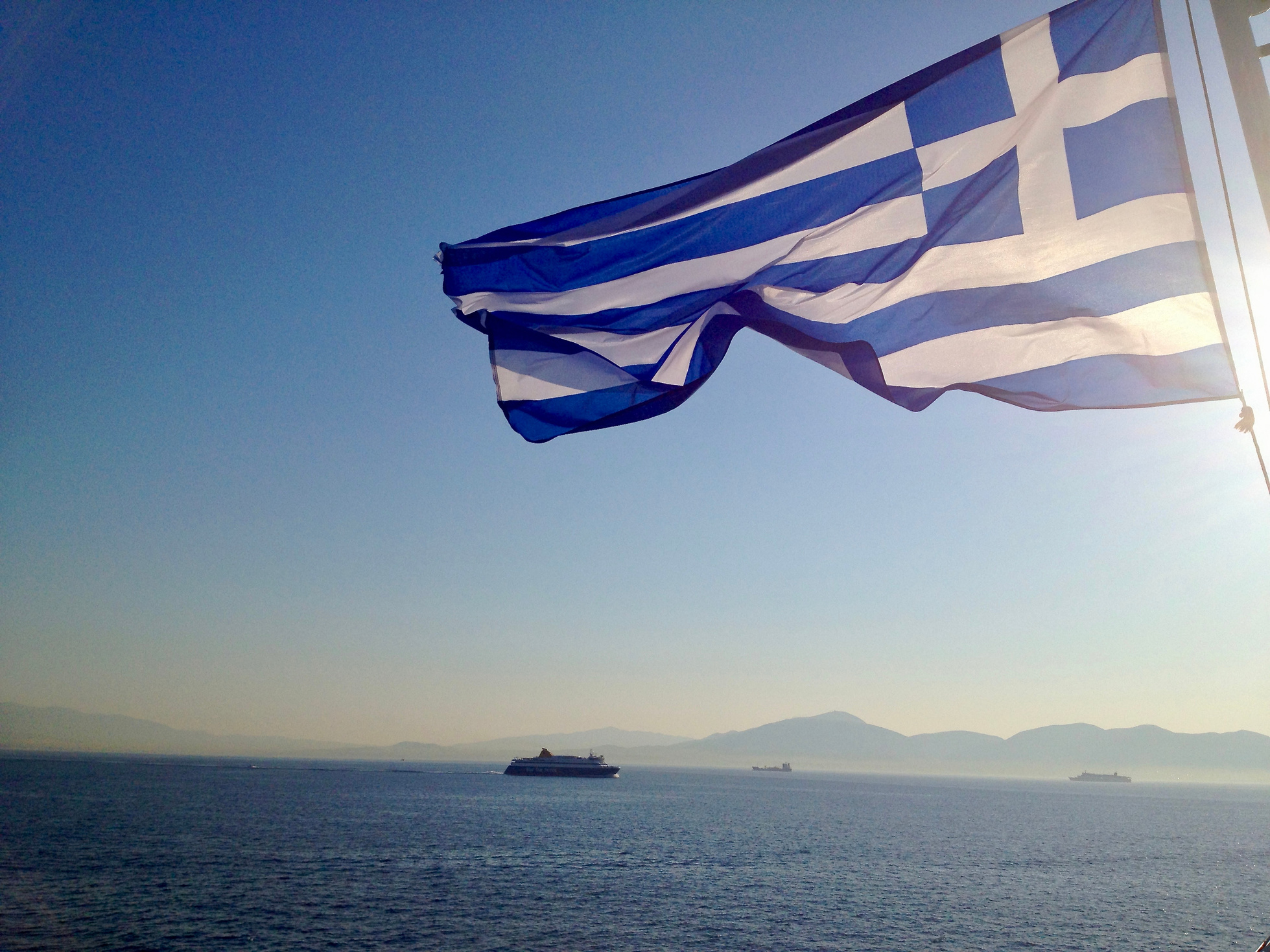 Greek flag over the sea